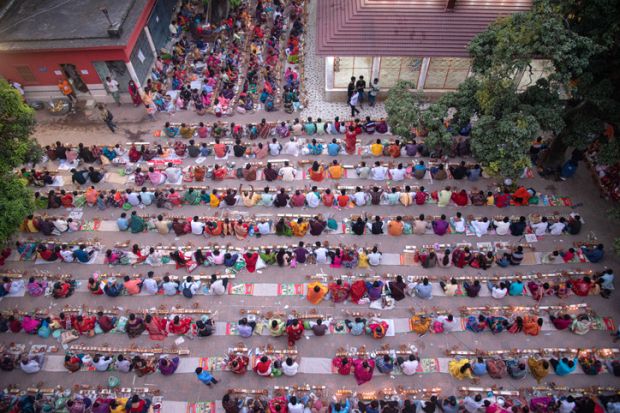 Thousands of Hindu devotees sits with Prodip and prays to God in front of Shri Shri Lokanath Brahmachari Ashram temple.