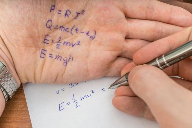 Test answers written on the palm of a hand