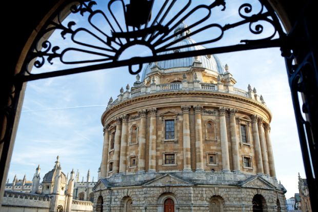 A view of the Radcliffe Camera through a gate at the University of Oxford in England