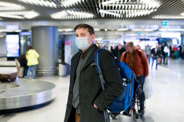 coronavirus face-mask arrival hall airport
