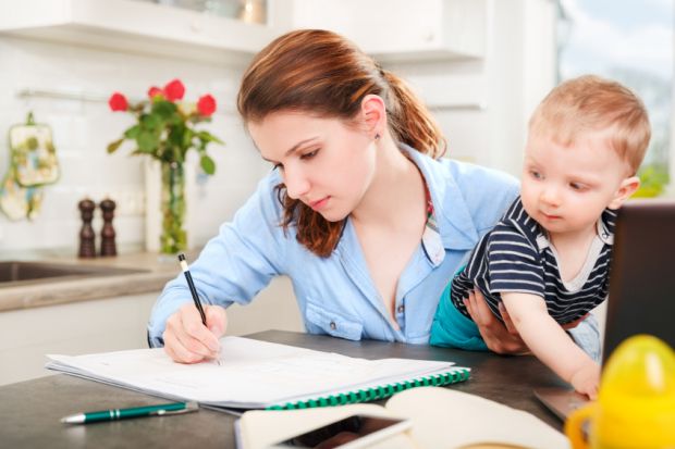 Student mother working with baby