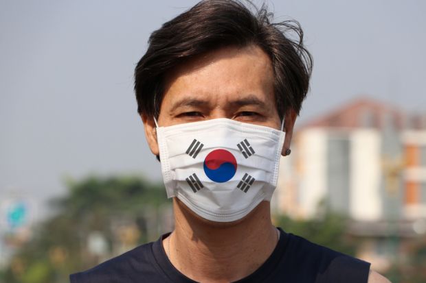 Man wearing a mask with the South Korean flag