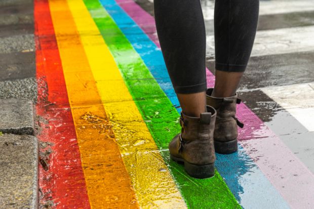 Legs walking on rainbow crossing, LGBT+ inclusion