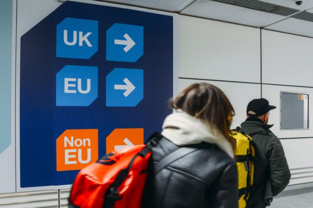 London Gatwick, March 2nd, 2018 Passengers walks past sign prior to immigration control pass a sign pointing towards queues for UK, EU and Non-EU passport holders. In April 2019, UK is set to leave the European Union - Brexit theme