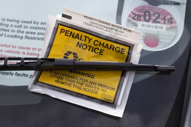 London, UK - May 16th, 2013 A parking penalty notice, under a windscreen wiper on a vehicle. 