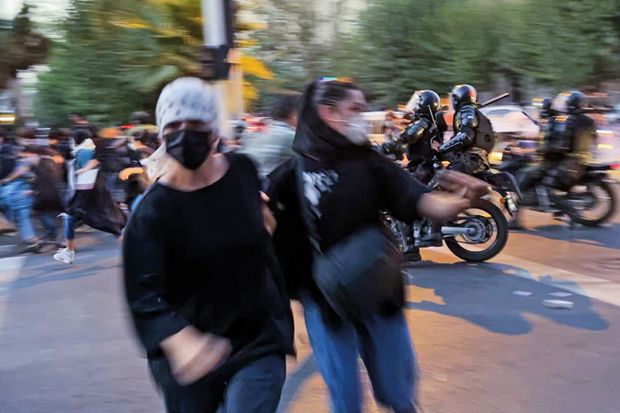 People gather during a protest for Mahsa Amini, who died after being arrested by morality police allegedly not complying with strict dress code in Tehran, Iran on September 19, 2022