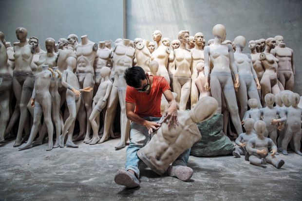 An employee works on a mannequin at the 'A Top Mannequin' factory