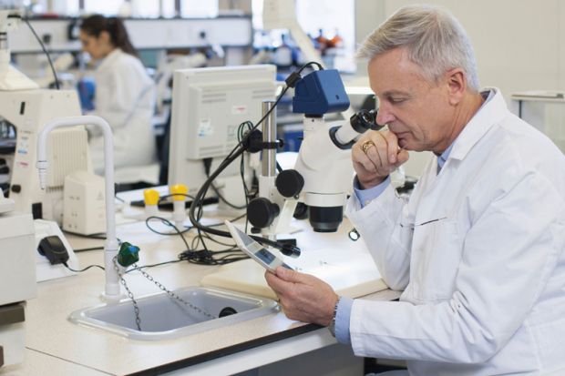 Male scientist using tablet computer in laboratory