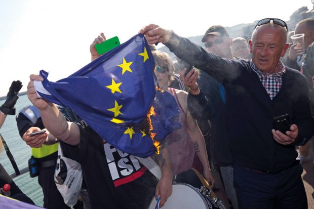 Man burning European Union (EU) flag