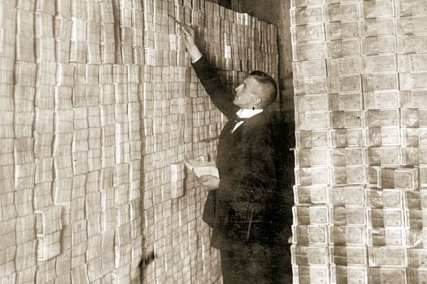 Man counting banknotes, Weimar Republic, Germany, 1923
