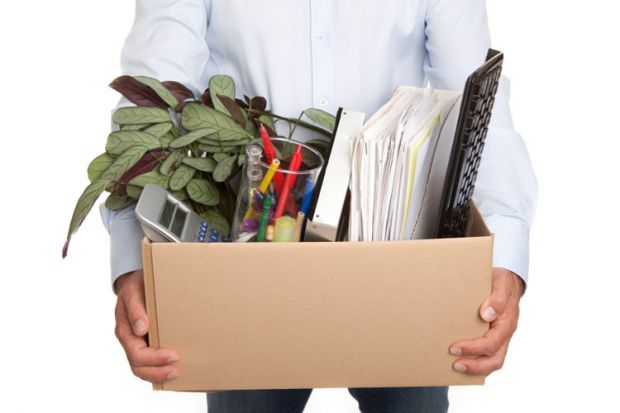 Man holding a box filled with work-related items