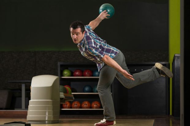 Man in dramatic bowling pose