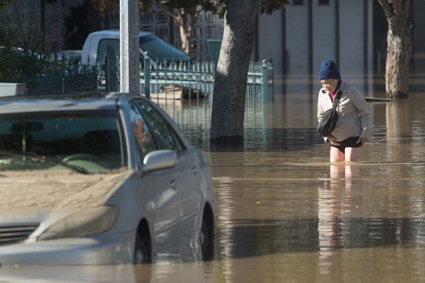 man in flood waters California