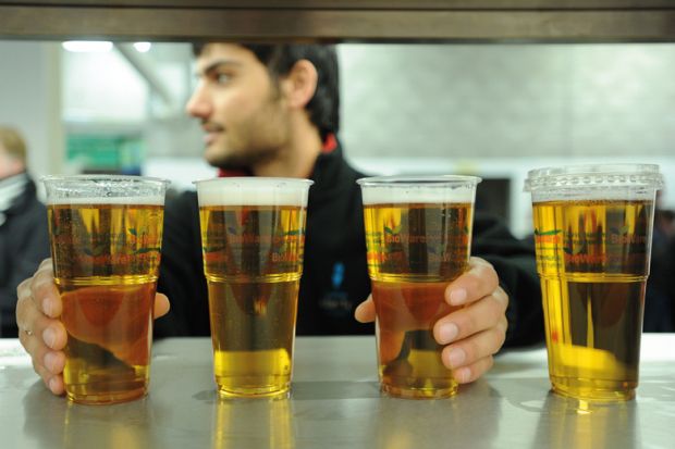 Man reaching for pints of lager