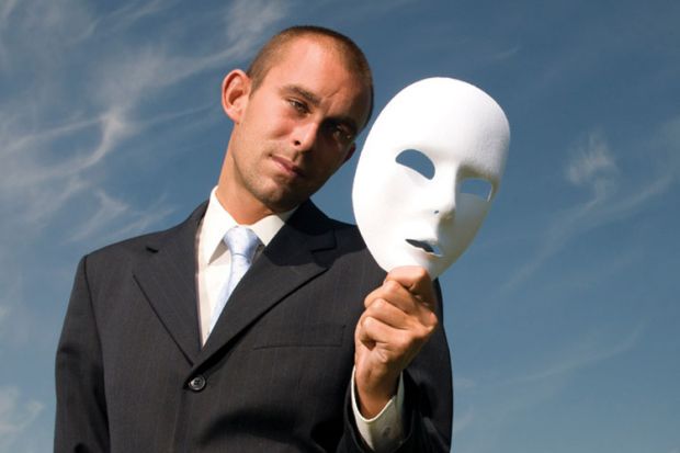 Businessman holding white face mask