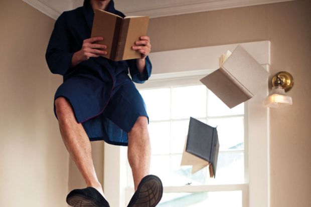 Man sitting and reading in mid air