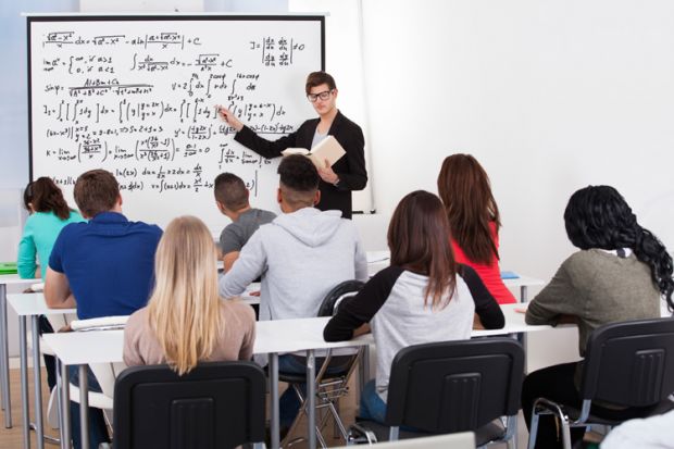 Man teaching mathematics to class of students