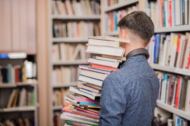 Man carrying lots of books