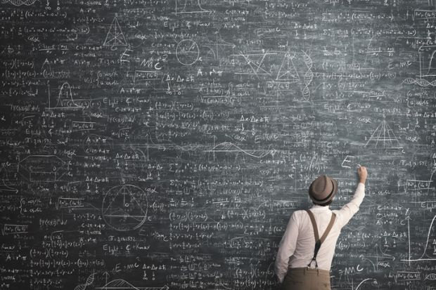 A maths teacher with a huge blackboard