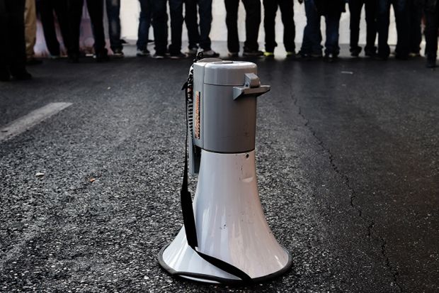 Megaphone on road in front of crowd of people