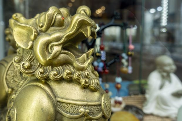 Melbourne, Australia - May 12, 2019 Chinese lion figurine. Chinatown shop along Little Bourke Street in the Central Business District (CBD) that sells oriental souvenirs.
