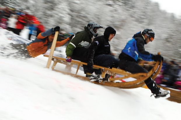 Men riding wooden sledge, Garmisch-Partenkirchen, 2012