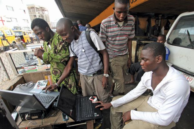 Men working on laptops, Obalende District, Lagos, 2010