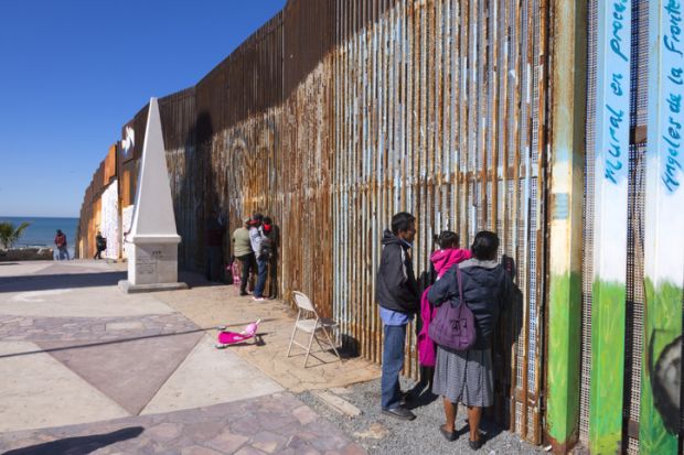 Mexican families living in Tijuana visit family members living in the US at the border wall in Playas de Tijuana