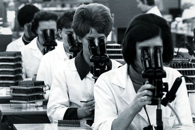 Team of researchers with microscopes