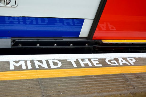 'Mind the Gap' sign painted on London Underground floor