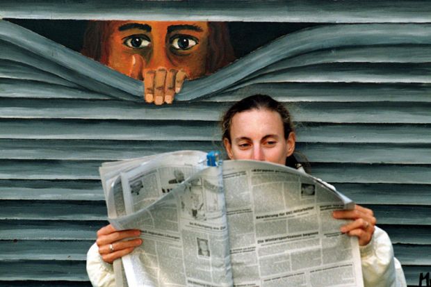 Mural peering at person reading newspaper