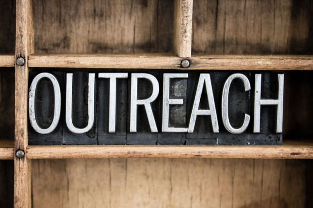 Outreach sign carved in wood