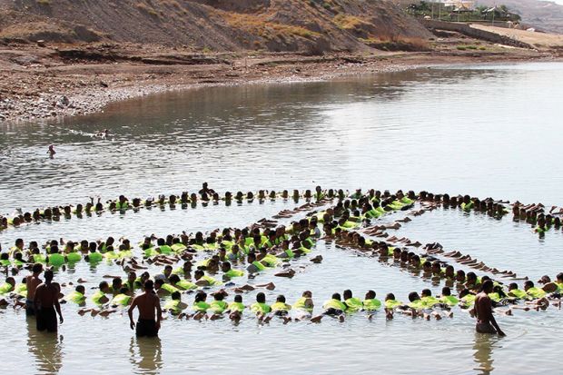 people make the shape of a peace sign in the water