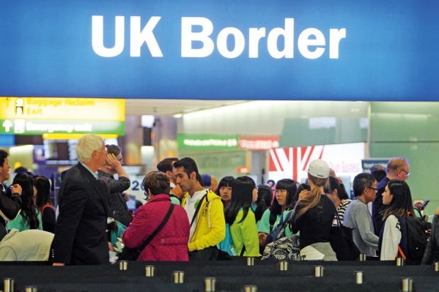 People queuing at UK border, Heathrow Airport, London