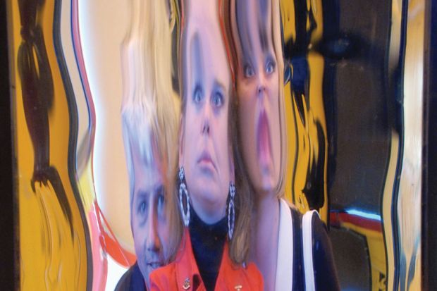 People's faces distorted in hall of mirrors reflection