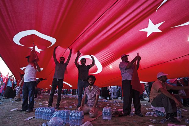 People underneath a Turkish flag