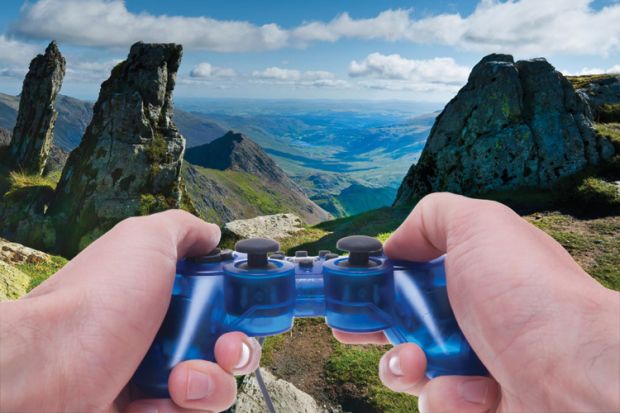 Person holding Sony PlayStation controller in hills