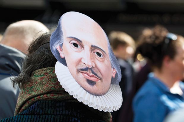 A person wearing a Shakespeare mask