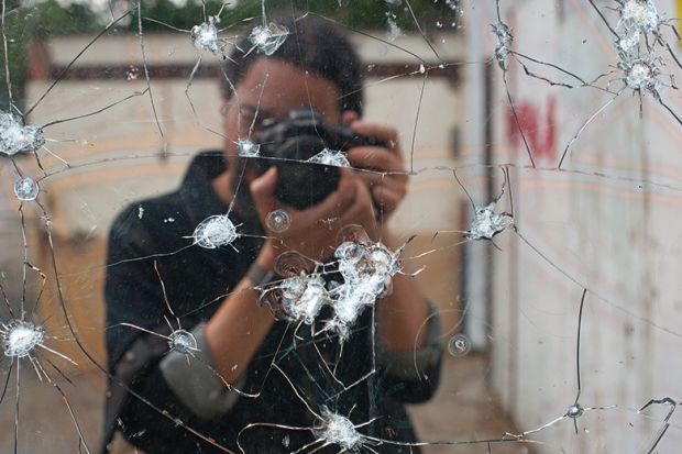 Photo of bullet holes in mirror