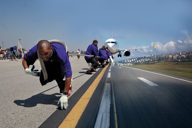 people pull plane along runway