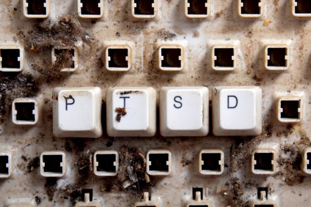 Post-traumatic stress disorder (PTSD) spelled on dirty, broken keyboard keys