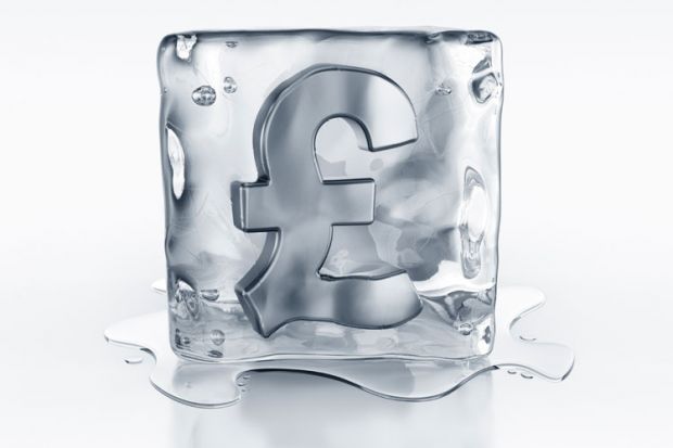 Pound currency symbol frozen in ice block
