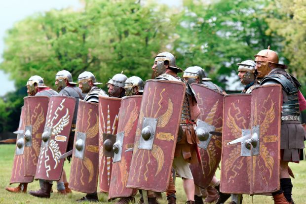 reenactment of Roman legionary during battle