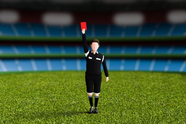 A football referee issues a red card