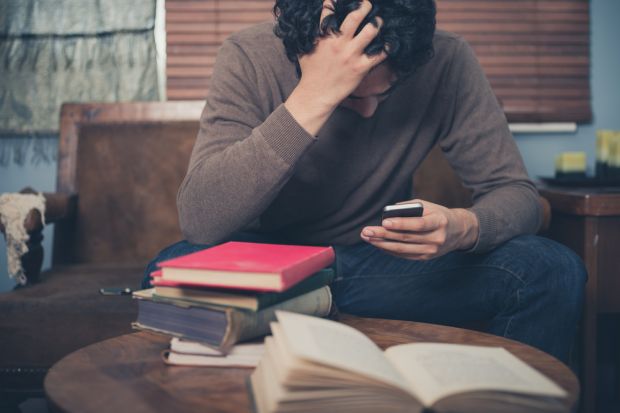 Man revising with books