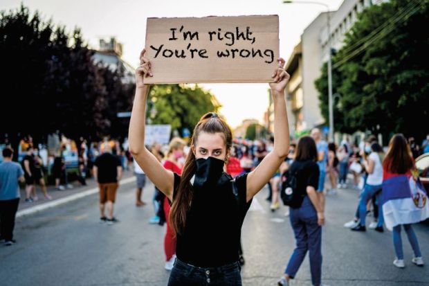 woman holding protest placard 