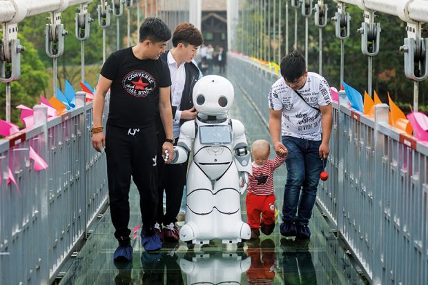 People with robot on bridge