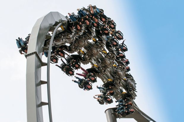 A roller coaster at the top of a loop