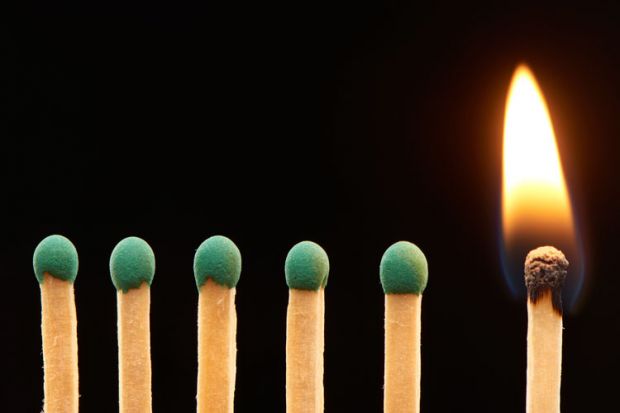 Row of green matches, one burning