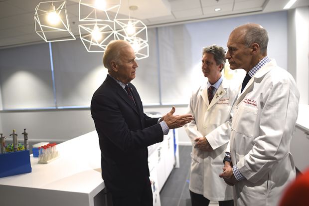 Joe Biden (L) meets with (C-R) Dr. Bruce Levine and Dr. Carl June, while touring the University of Pennsylvania, Perelman School of Medicine and Abramson Cancer Center in Philadelphia, Pennsylvania January 15, 2016.